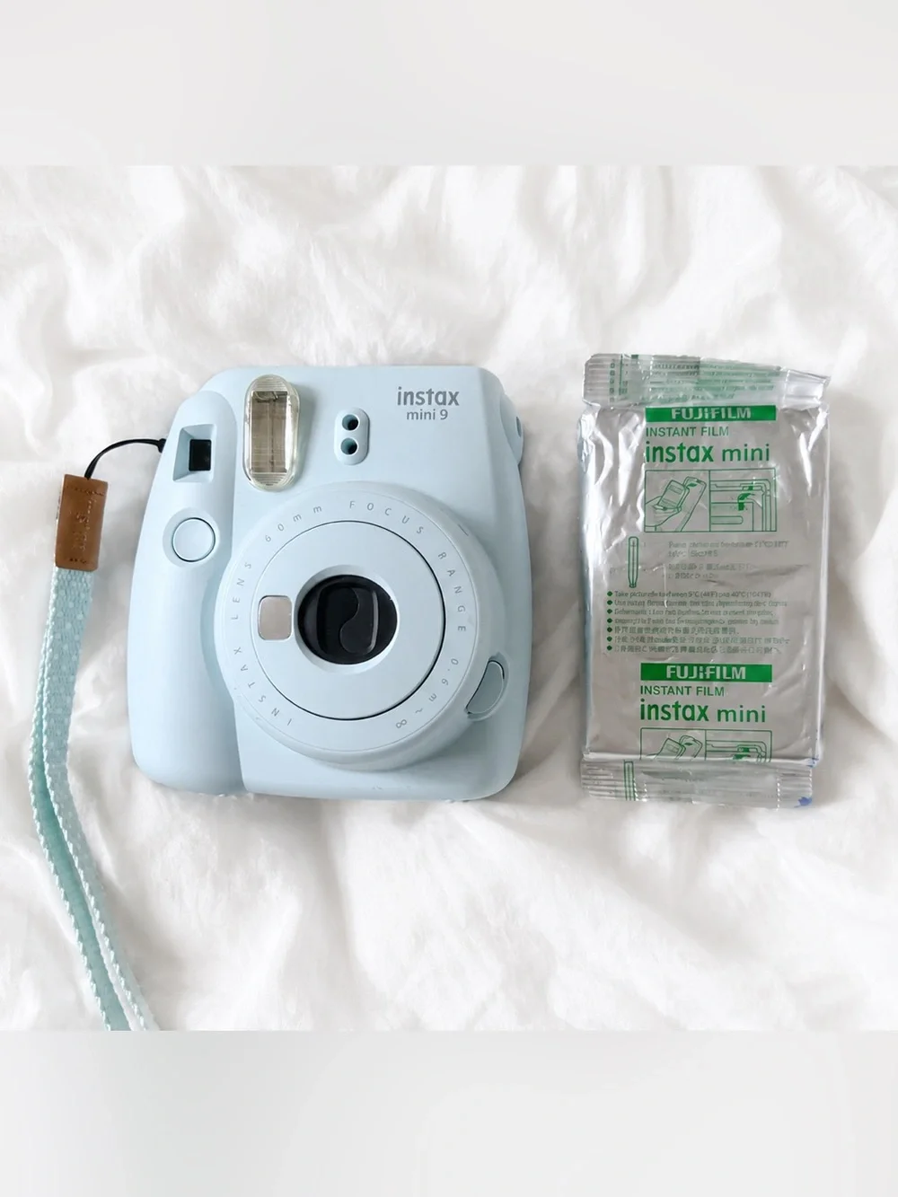 Fujifilm Instax Mini 9 camera in the color Ice Blue + a pack of film.